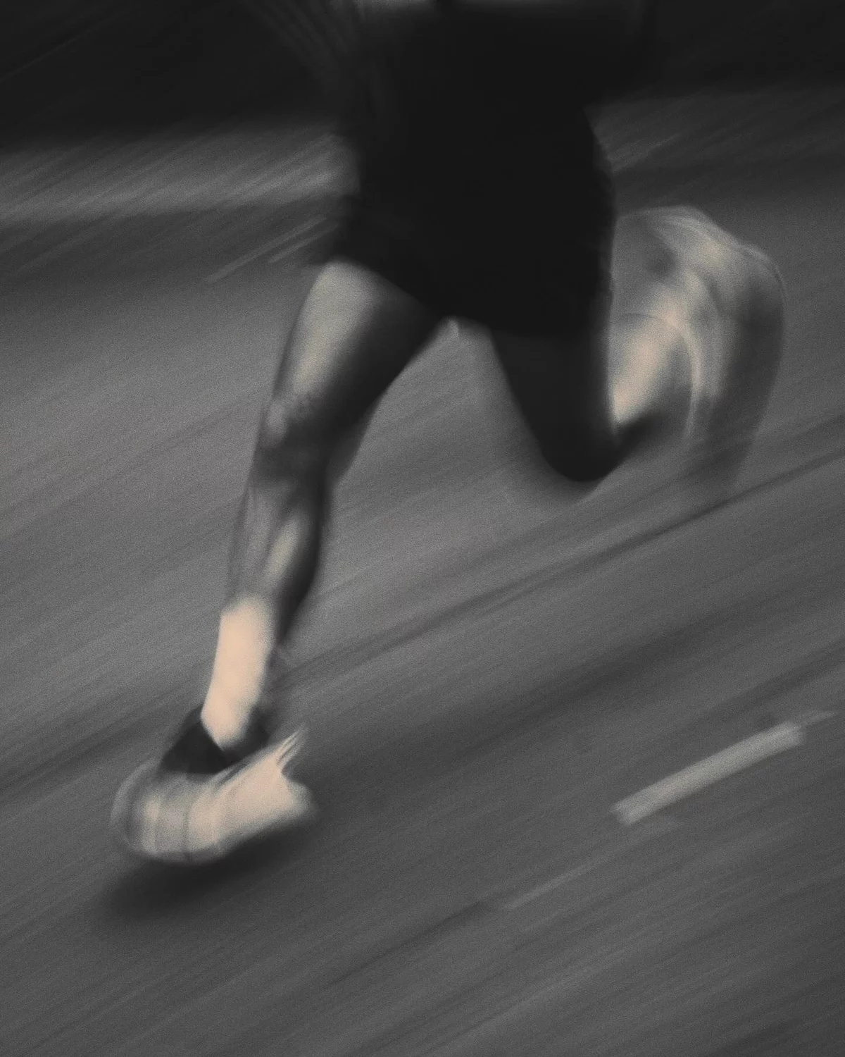 Motion-blurred runner in black and white