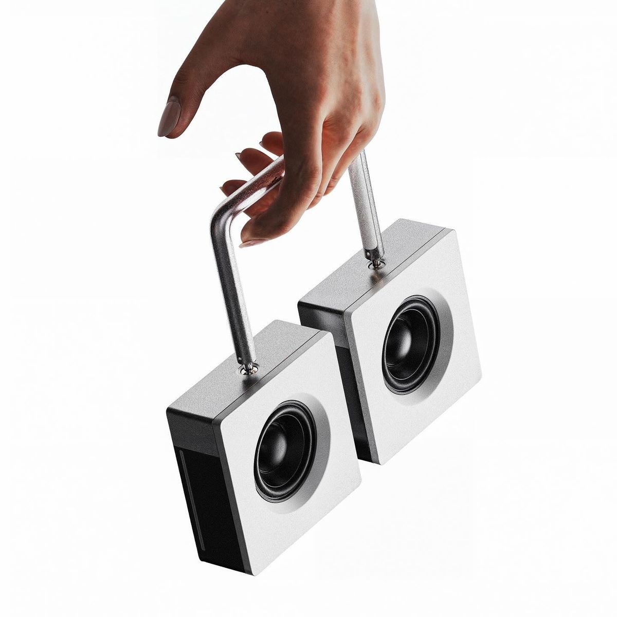 Hand carrying two portable speakers